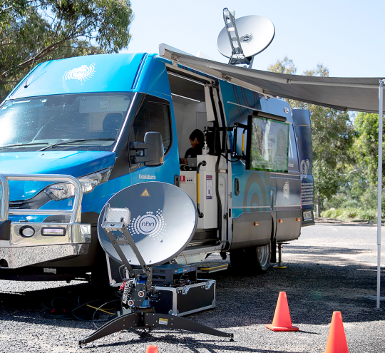 Commercial van on the street using an NBN satellite dish.