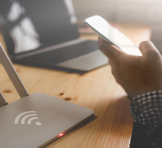 Person on phone next to wifi router