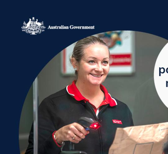 Woman serves man over the counter at Australia Post.