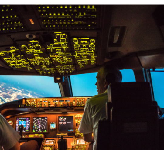 Two pilots working in the cockpit.