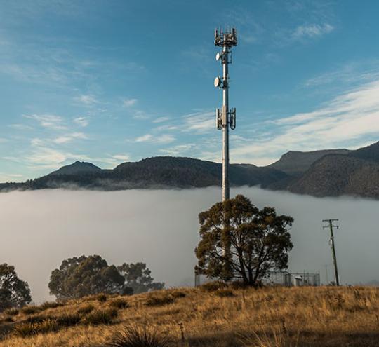 Telecommunications tower over a foggy valley