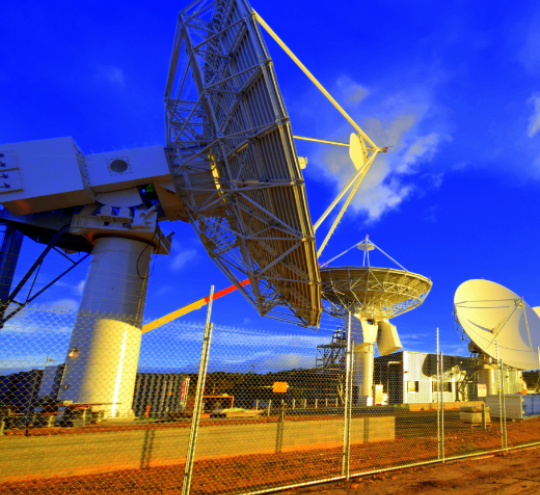 Four large NBN satellites at a rural location.