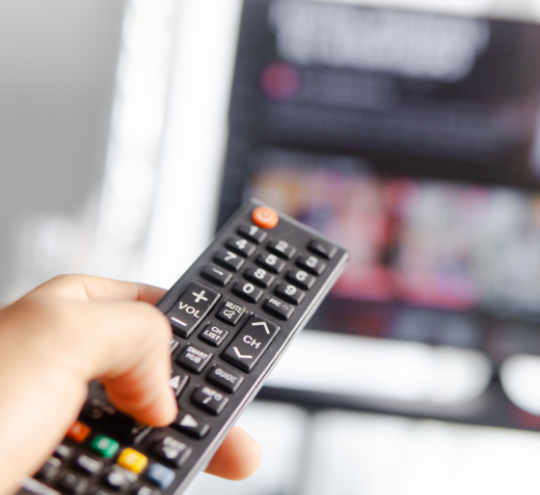 remote control being used on television