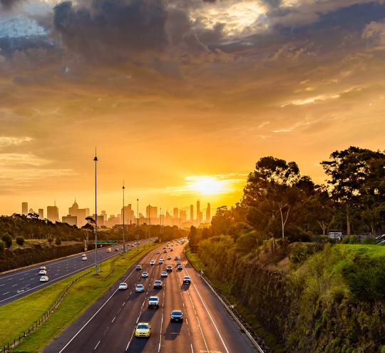 sunset over highway traffic