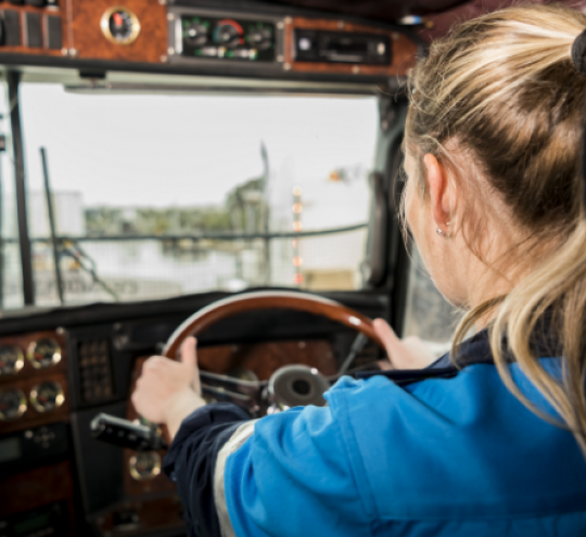 Truck driver with hands on steering wheel