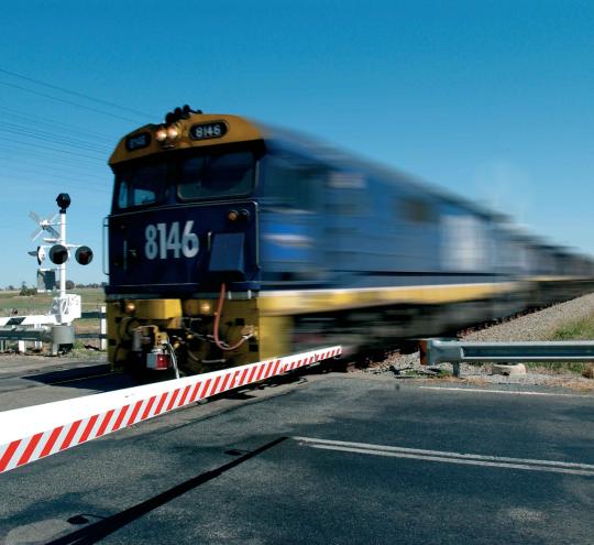 Freight train in regional Australia at a crossing.