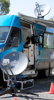 Commercial van on the street using an NBN satellite dish.