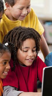 Children looking at a computer