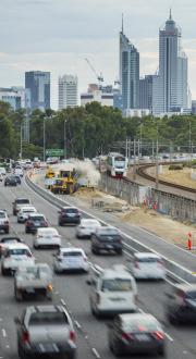 Multiple vehicles driving along the Mitchell Freeway, Western Australia.