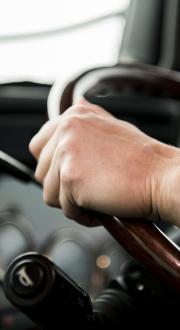 Close-up image of truck driver at the wheel