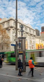 tram passing pedestrians