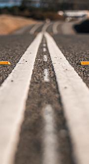 Improved road surface with double white centre lines.