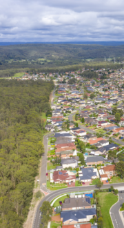 Aerial view of houses in the suburb of Glenmore Park in NSW, Australia of residential area and motorway in Brisbane Queensland.