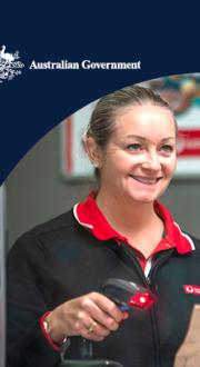 Woman serves man over the counter at Australia Post.