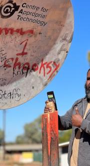 Co-researcher for the Mapping the Digital Gap research project Mel Langdon, using the CAT mobile hotspot in Yuelamu, which enables access to the mobile signal from Yuendumu 43km away. 