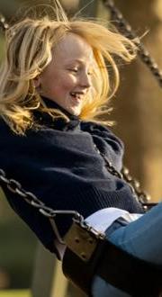 Girl on a swing in the sunshine