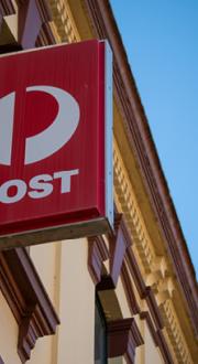 Australia Post sign on the side of a heritage building.