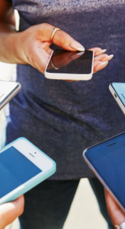 5 people looking at their mobile phones