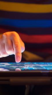 Close up of a young boy using a tablet.