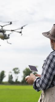 man controlling drone in flight