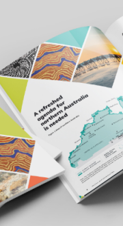 Multiple printed copies of the Northern Australia Action Plan laid out flat with images from northern Australia on the cover including First Nations artworks.