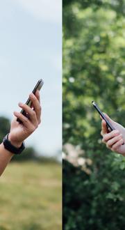 a man and a woman looking at their mobile phones