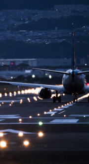 Plane taking off from a run-way at night.