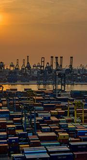 Port with shipping containers and cranes.