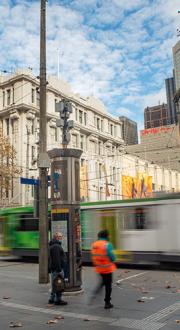 tram passing pedestrians