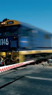 Freight train in regional Australia at a crossing.