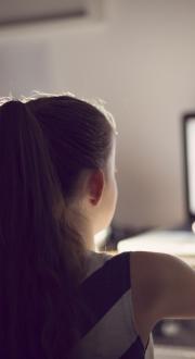 Two young girls using a computer.