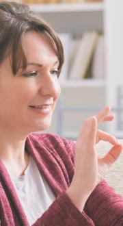 Deaf woman using Auslan to talk through her mobile phone.